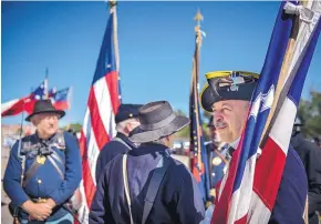  ??  ?? Dwight Thompson of the First New Mexico Volunteers re-enactor group prepares to lead his portion of the Corrales Fourth of July Parade on Thursday.