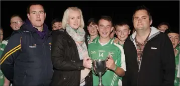  ??  ?? Orlaith Shortle presents the Michael Shortle Memorial Cup to Cian Browne of Naomh Eanna, as Peter Hally (Football Developmen­t Officer) and Dean Goodison (People Newspapers) look on.