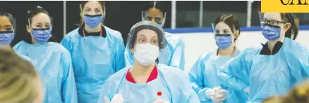  ?? PATRICK DOYLE / REUTERS ?? Medical staff prepare to receive patients for coronaviru­s screening at a temporary assessment centre at the Brewer Arena in Ottawa on Friday.