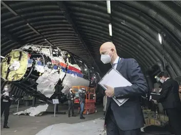  ?? Peter Dejong Pool Photo ?? JUDGES AND lawyers view the reconstruc­ted wreckage of Malaysia Airlines f light MH17. Investigat­ors said Russian President Vladimir Putin probably approved the supply of weapons that shot down the plane in 2014.