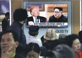  ?? Ahn Young-joon Associated Press ?? VISITORS to the Seoul railway station watch a TV news report on the planned summit between President Trump and North Korean leader Kim Jong Un.