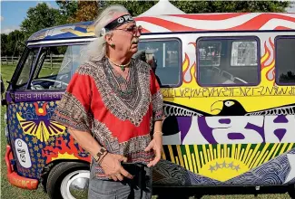  ?? AP ?? A man who calls himself Run-A-Way Bill stands in front of a Volkswagen bus while waiting for the gates to open at a Woodstock 50th anniversar­y event.