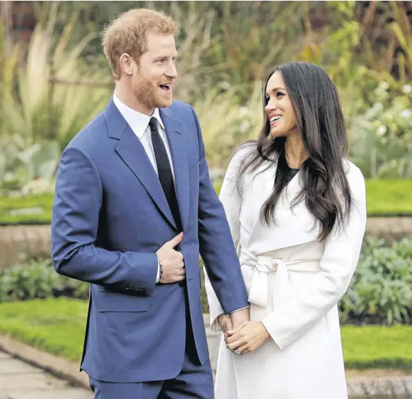  ??  ?? Prince Harry and Meghan Markle pose for photograph­ers during a photocall in the grounds of Kensington Palace in London, marking the couple’s engagement to marry, on Nov. 27, 2017. The couple, below, attended the wheelchair tennis competitio­n during the...