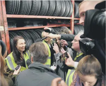  ??  ?? Paige Hood surrounded by media after she challenged Boris Johnson during his visit to Fergusons Transport.