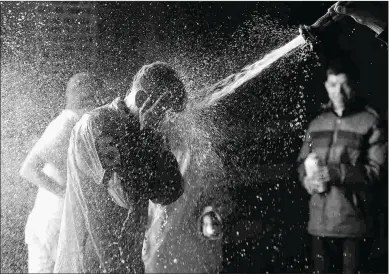  ?? CHELSEA DURAND/NYRA ?? Hector Diaz Jr. gets sprayed after his first victory, which came Jan. 15 aboard Honorable Jonas.