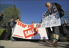  ?? THE ASSOCIATED PRESS ?? Cory Doctorow, right, walks in front of other protestors in Los Angeles outside the headquarte­rs of the regulatory body for domain names, the Internet Corporatio­n for Assigned Names and Numbers.