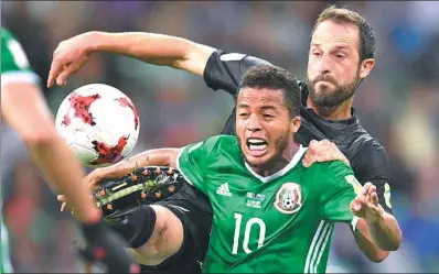  ?? MARTIN MEISSNER / AP ?? Mexico’s Giovani Dos Santos (10) and New Zealand’s Andrew Durante vie for possession during their Confederat­ions Cup Group A match at Fisht Stadium in Sochi, Russia, on Wednesday. Mexico won 2-1.