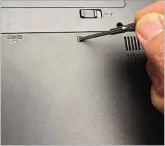  ??  ?? Unscrew a plastic hatch on the bottom of your laptop to install memory