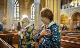  ??  ?? Parishione­rs wearing face masks bless themselves at the end of mass at St Patrick’s catholic cathedral, Armagh. Photograph: Liam McBurney/PA
