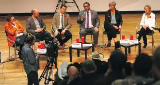  ?? DARREN MAKOWICHUK ?? Stakeholde­rs of Calgary’s potential Olympics bid, including Mayor Naheed Nenshi, fourth from left, gather at the new Central Library Wednesday for a CBC Calgary town hall.