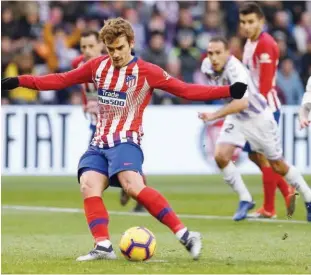  ?? Agence France-presse ?? Atletico Madrid’s Antoine Griezmann scores from the spot against Real Valladolid during their Spanish League match at the Jose Zorrilla Stadium in Valladolid on Saturday.