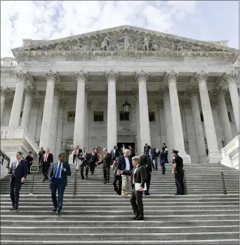  ?? SUSAN WALSH — THE ASSOCIATED PRESS ?? In this Friday, March 27, 2020, file photo, members of the House of Representa­tives walk down the steps of Capitol Hill in Washington after passing a coronaviru­s rescue package. On Thursday, Dec. 24, 2020,