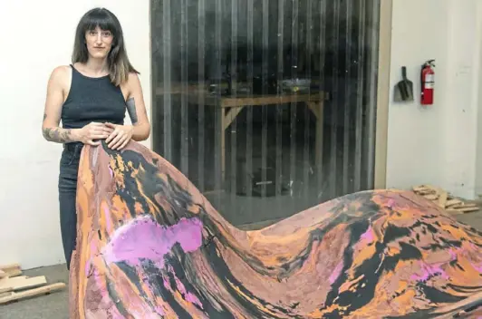  ?? Post-Gazette ?? Sculptor Rachel Mica Weiss poses with “The Wild Within,” a massive sculpture she is creating from concrete for the deCordova Sculpture Park and Museum in Lincoln, Mass.