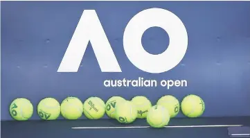  ??  ?? Tennis balls are pictured in front of the Australian Open logo before the tennis tournament in Melbourne. — Reuters photo