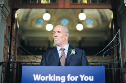  ??  ?? Premier John Horgan answers questions from the media following the speech from the throne in the legislativ­e assembly in Victoria on Tuesday. — THE CANADIAN PRESS