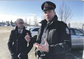  ??  ?? EPS Staff Sgt. Steve Sharpe and the Alberta Motor Associatio­n’s Jeff Kasbrick discuss how thieves choose cars — either to steal or simply break into — at Southgate Centre on Tuesday.