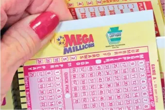  ?? AP PHOTO/GENE J. PUSKAR ?? A Mega Millions entry card is displayed at the Cranberry Super Mini Mart on Thursday in Cranberry, Pa.
