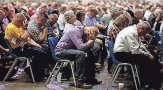  ??  ?? People pray during the annual meeting of the Southern Baptist on June 14, 2016, in St. Louis. JEFF ROBERSON / AP