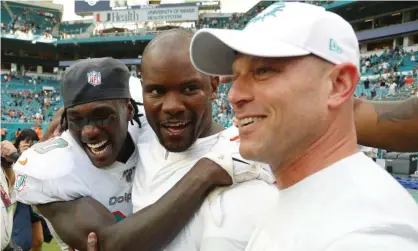  ?? Photograph: Wilfredo Lee/AP ?? Miami Dolphins defensive back Chris Lammons, left, hugs head coach Brian Flores, center, after the Dolphins’ victory.