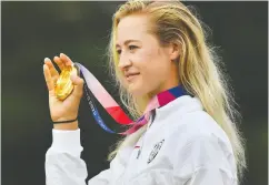  ?? KAZUHIRO NOGI / AFP VIA GETTY IMAGES FILES ?? Gold medallist American Nelly Korda holds her medal on the podium of the women’s golf individual stroke play
during the Tokyo 2020 Olympic Games.