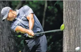  ?? KEVIN C. COX / GETTY IMAGES ?? Tiger Woods (teeing off on the second hole Friday) can secure a spot in the FedEx Cup playoffs with a victory this week at the Wyndham Championsh­ip.