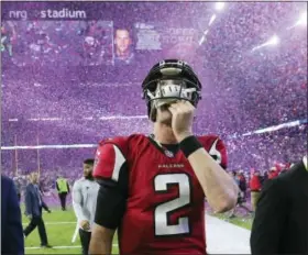  ?? CURTIS COMPTON — ATLANTA JOURNAL-CONSTITUTI­ON VIA AP, FILE ?? In this photo taken file photo, Atlanta Falcons quarterbac­k Matt Ryan reacts after losing Super Bowl 51 as the screen flashes New England Patriots quarterbac­k Tom Brady and confetti flies in Houston. The Falcons’ biggest disappoint­ment was their...