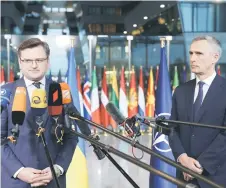  ?? — AFP photo ?? Kuleba (left) and Stoltenber­g speak to the press as they arrive for a meeting of Nato foreign ministers at Nato headquarte­rs in Brussels.