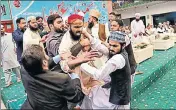  ?? AFP ?? Pakistani security personnel and organisers of a gathering tackle one of the men who threw a shoe at Nawaz Sharif.