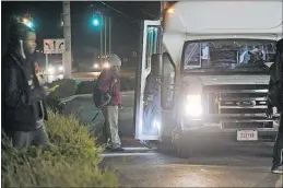  ??  ?? Workers board the 6:30 a.m. GREAT (Groveport Rickenback­er Employee Access Transit) shuttle after getting off COTA buses from their homes around Franklin County. The shuttle takes them to warehouse jobs near Rickebacke­r Airport and is paid for by the...