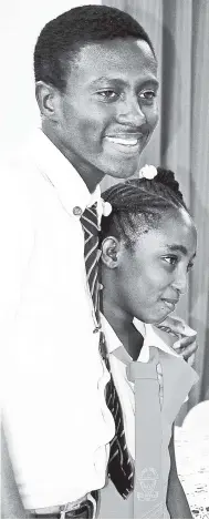  ?? PHOTOS BY CARL GILCHRIST ?? Youth mayor of St Ann’s Bay, Bobby Francis of York Castle High School, gives his deputy, Davi-Ann James, of Priory Primary and Infant School, a congratula­tory hug after they were elected.