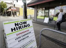  ?? ELAINE THOMPSON — THE ASSOCIATED PRESS ?? Jobs are coming back — this sidewalk reader board advertises for a remodeling company in Seattle — and the U.S. unemployme­nt rate fell to 13.3% in May, and 2.5million jobs were added, a surprising­ly positive reading in the midst of a recession that has paralyzed the economy and depressed the job market in the wake of the viral pandemic.