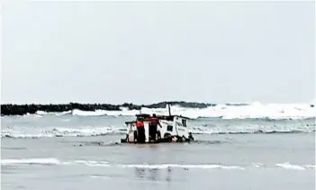  ?? OREGON STATE POLICE ?? Newport authoritie­s examine the wreckage of a crabbing ship that capsized off the Oregon coast, killing three.