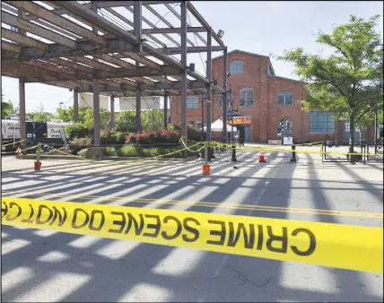  ?? AP PHOTO ?? Police crime scene tape keeps people away from the brick Roebling Wire Works building in Trenton, N.J., hours after a shooting broke out there at an all-night art festival early Sunday.