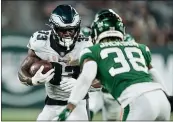  ?? JOHN MINCHILLO — THE ASSOCIATED PRESS ?? Philadelph­ia Eagles’ Elijah Holyfield (33) rushes as New York Jets’ Lamar Jackson (38) closes in during the second half of an NFL preseason football game Friday.