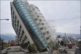  ?? CENTRAL NEWS AGENCY VIA AP ?? A residentia­l building leans on a collapsed first floor following an earthquake, Wednesday in Hualien, southern Taiwan. Rescue crews continue to try free people from damaged buildings after a strong earthquake hit near Taiwan’s east coast.