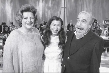  ?? RICHARD DREW/AP PHOTO ?? Conductor Mitch Miller performs for photograph­ers with singers Rosemary Clooney (left) and Irene Cara (center) during a rehearsal, on Jan. 6, 1981, in New York for his NBC-TV special called “The Mitch Miller Show: A Sing Along Sampler.” Oscar, Golden Globe and two-time Grammy winning singer-actress Cara, who starred and sang the title cut from the 1980 hit movie “Fame” and then belted out the era-defining hit “Flashdance ... What a Feeling” from 1983’s “Flashdance,” has died at age 63.