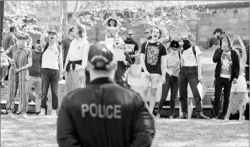  ??  ?? A policeman watches on as supporters of same-sex marriage in Australia protest near a counter-demonstrat­ion against same-sex marriage at a park in Sydney, Australia. — Reuters photo