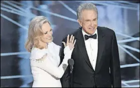  ?? KEVIN WINTER / GETTY IMAGES ?? Actors Faye Dunaway (left) and Warren Beatty speak on stage during the 89th Annual Academy Awards. Dunaway announced the wrong winner for best picture.