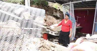  ?? Photo: Ronald Kumar ?? Flea Market stall owner, Chandra Wati, removes her belonging after a landslide crashed into her stall yesterday.