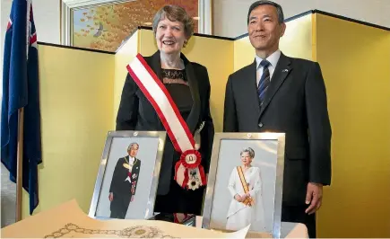  ?? PHOTO: ROSS GIBLIN/STUFF ?? Former Prime Minister Helen Clark is conducted into the Order Of The Rising Sun by Japan’s ambassador to New Zealand, Toshihisa Takata.