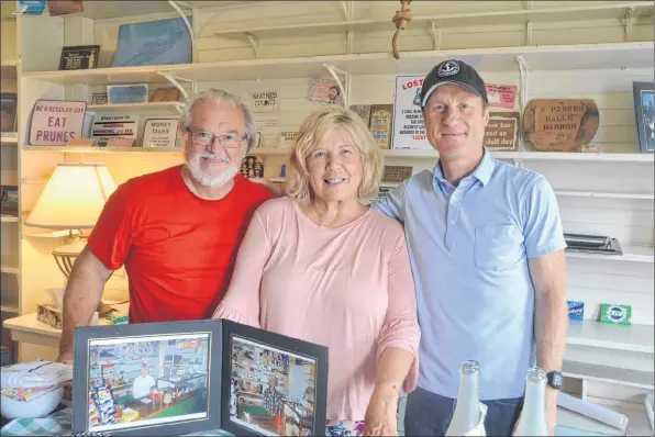  ?? KIRK STARRATT ?? New managers Dick Killam and Madonna Spinazola and owner Craig Parker pose for a photo at the newly reopened Parker’s General Store in Halls Harbour.