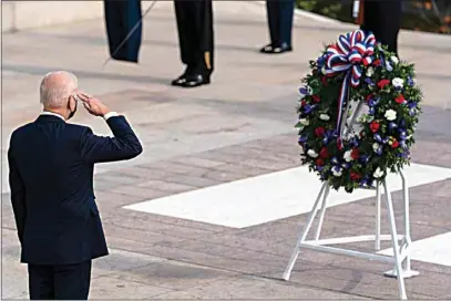  ?? ALEX BRANDON / AP ?? President Joe Biden salutes before placing a wreath during a centennial ceremony for the Tomb of the Unknown Soldier in Arlington National Cemetery on Veterans Day on Thursday in Arlington, Va.