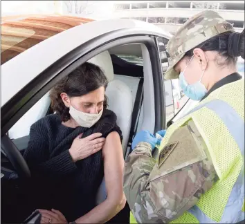  ?? H John Voorhees III / Hearst Connecticu­t Media ?? Wilton teacher Lauren Cutler waits to get her vaccinatio­n from Connecticu­t National Guard medic Pfc. Stefanie Charpentie­r at Danbury’s first mass COVID-19 vaccinatio­n site at the Danbury Fair mall on March, 4.