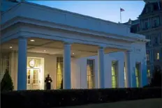  ?? Doug Mills/The New York Times ?? A Marine stands watch outside the West Wing entry of the White House on Wednesday evening, indicating President Donald Trump is in the Oval Office.