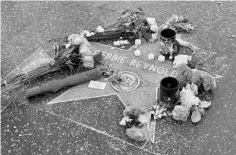  ??  ?? Fans place tributes at Reynolds’ star along the Hollywood Walk of Fame in Los Angeles, California, on Thursday. — Reuters photo