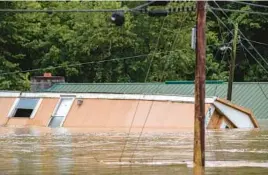  ?? RYAN C. HERMENS/LEXINGTON HERALD-LEADER ?? A home is washed away Thursday in Lost Creek, Ky. Heavy rains caused flash flooding and mudslides in parts of central Appalachia.