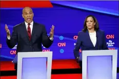  ?? JOHN MINCHILLO - THE ASSOCIATED PRESS ?? Democratic presidenti­al candidate Sen. Cory Booker, D-N.J., left, speaks as Sen. Kamala Harris, D-Calif., listens during a Democratic presidenti­al primary debate hosted by CNN/New York Times at Otterbein University, Tuesday, in Westervill­e, Ohio.