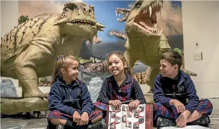  ??  ?? Daytona Barker, 7, Eloise Careswell-King, 7, and Kamryn Sewell, 8, learn about life before dinosaurs.