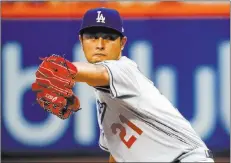  ?? Julie Jacobson ?? The Associated Press Yu Darvish delivers in the first inning of his Dodgers debut Friday at Citi Field. The four-time All-star blanked the Mets on three hits and one walk and struck out 10 over seven innings in Los Angeles’ 11th win in 12 games.