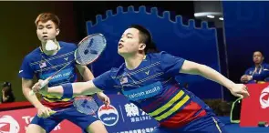  ??  ?? Quick reflexes: Aaron Chia (right) and Soh Wooi Yik returning a shot to South Korea’s Chung Eui-seokKim Duk-young during the first round at the Youth Olympic Sports Park Arena yesterday.